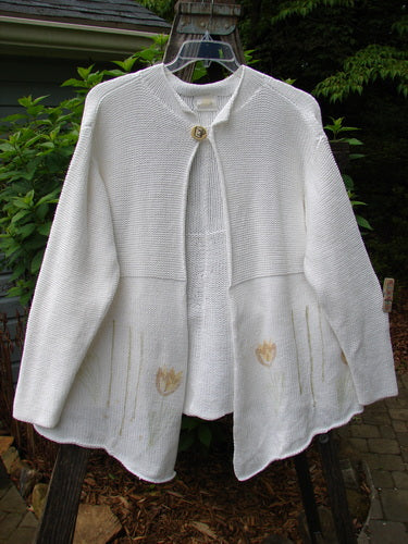 1999 Rollneck Cardigan Sweater Pastel Tulip Pure White OSFA featuring a flower design, rolled seams, dual knitting, varying hemline, and double shiny porcelain button closure.