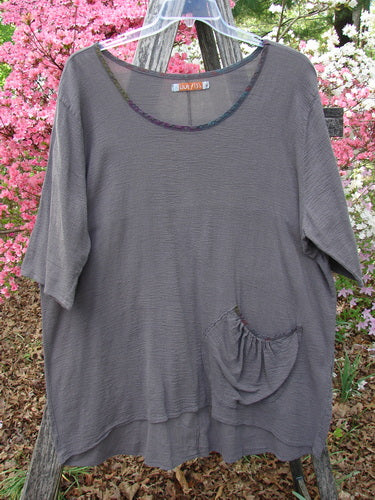 Barclay Gauze Contrast Ditsy Daisy Pocket Top Unpainted Stone Size 1 hanging on a tree branch, showcasing its scooped neckline, floral-patterned drop pocket, and lightweight cotton gauze texture, ideal for summer layering.