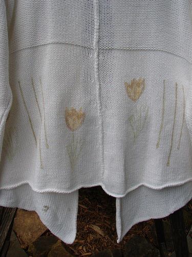 1999 Rollneck Cardigan Sweater in Pure White featuring pastel tulip embroidery, sectional rolled seams, and a varying hemline.