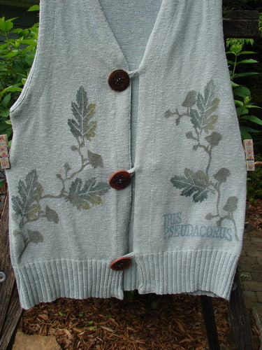 1998 Botanicals Sprig Vest River Altered Size 1: Vest adorned with leaf patterns and three oversized handmade stoneware buttons, featuring a deep V neckline and varying knit textures.