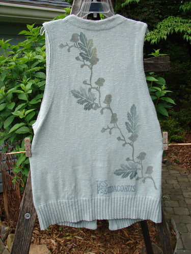 1998 Botanicals Sprig Vest River Altered Size 1: A cotton knit vest with oversized stoneware buttons, deep V neckline, and varying ribbed textures, hanging on a clothesline.