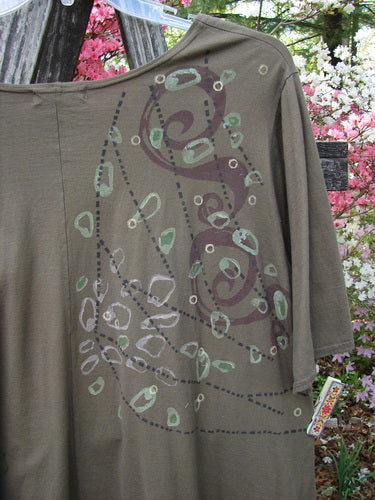Barclay Hi Low Top Side Art Curly Cue Bark Size 1 hanging on a clothesline, showcasing its abstract swirling pattern and sweeping A-line shape, with three-quarter sleeves and a scooped neckline.