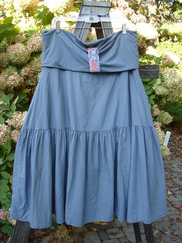 Barclay NWT Linen Fold Over Trinity Skirt Unpainted Diatom Size 2 hanging outdoors, showcasing its organic linen fabric, fold-over cotton panel waistline, and fluttery hemline.