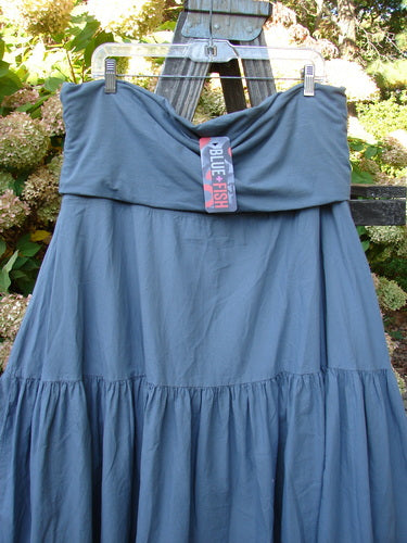 Barclay NWT Linen Fold Over Trinity Skirt Unpainted Diatom Size 2, displayed hanging on a clothesline, showcasing its full paneled waistline and flutter-like lower hem.