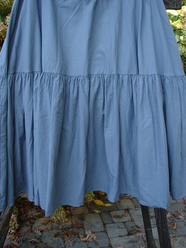Barclay NWT Linen Fold Over Trinity Skirt Unpainted Diatom Size 2 displayed on a rack, highlighting its full paneled waistline and A-line hem with a flutter-like lower.