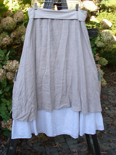 Barclay Linen Fold Over Two Tier Skirt Translucent Daisy Mallow Size 1 displayed on a mannequin, highlighting its dual hemline, paneled waistline, and soft daisy-themed lower border.