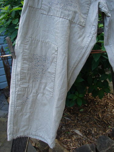 Magnolia Pearl NWT European Denim Lilou Trouser Natural Pinstripe OSFA hanging on a clothesline, showcasing its wider straight leg, contrasting patches, and detailed stitching, embodying vintage style from Bluefishfinder.com.