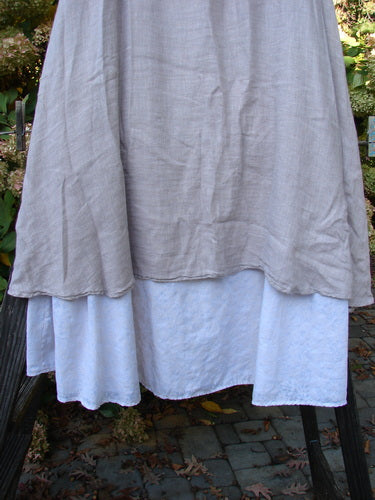 Barclay Linen Fold Over Two Tier Skirt Translucent Daisy Mallow Size 1, close-up showing the organic linen fabric, fold-over cotton panel waistline, and delicate daisy pattern on the lower border.