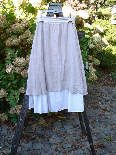 Barclay Linen Fold Over Two Tier Skirt Translucent Daisy Mallow Size 1 displayed on a rack, showcasing its dual-layered hemline and daisy motif at the bottom.