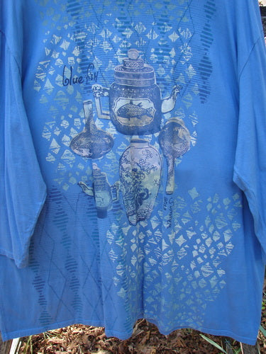 Barclay Long Sleeved Studio Tee Blue Fish Logo Ginger Jar Skylark Size 3 featuring stylized teapots and kettles, hanging outdoors with dry leaves beneath, showcasing its organic cotton design.