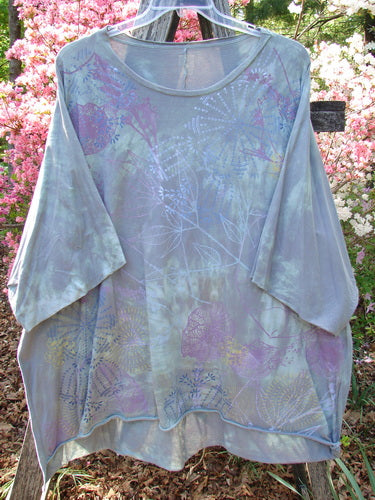 Barclay Flutter Collar Essential Tee Mood Garden Mottled Gray Grass OSFA, displayed outdoors with delicate flutter neckline, raw edge dolman sleeves, and a hi-low hemline, embodying Bluefishfinder.com's creative vintage style.