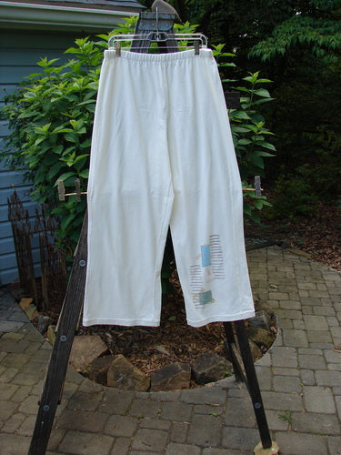 2001 Cotton Lycra Matchstick Pant Junk Drawer Fizz Size 2 hanging on a rack, showcasing its thin waistband and wide bottoms with a pockless design for a slimming look.