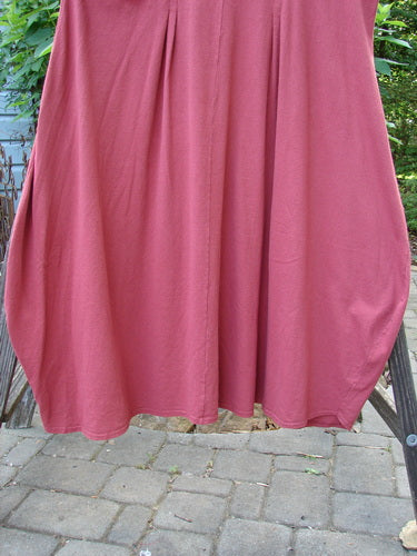 1993 Crepe Teapot Jumper Unpainted Cranberry Size 1 displayed on a clothes rack, showcasing its A-line flair, gathered pleats, and rounded neckline with a reverse triangular inset.