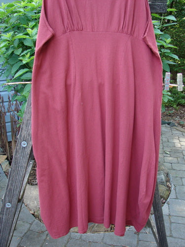 1993 Crepe Teapot Jumper Unpainted Cranberry Size 1 displayed on a wooden ladder, showcasing its rounded neckline, gathered upper back waist seam, and pleated vertical front accents.