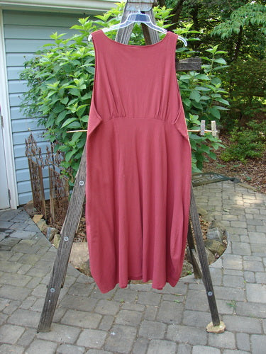 1993 Crepe Teapot Jumper Unpainted Cranberry Size 1 displayed on a clothes rack, showcasing its unique rounded neckline, pleated accents, and A-line flair.