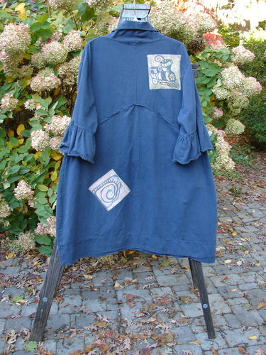 Barclay PMU Patched Twill Decora Brushed Flutter Coat Travel Navy Size 1 on a swing, featuring large buttons, ruffled 3/4 sleeves, and extensive patchwork detailing.