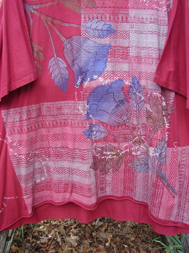 Barclay Art Tunic Tee Trailing Floral Deep Ruby OSFA, featuring geometric stripes and floral motifs, displayed outdoors. This loose-fitting, three-quarter sleeve tunic embodies Bluefishfinder.com's unique vintage style.