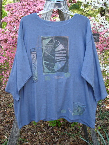 1995 Silk Noile Long Sleeved Top Leaf Fish Butterfly Dusk OSFA displayed on a wooden ladder outdoors, showcasing its abstract geometric designs and unique drape against a lush garden backdrop.