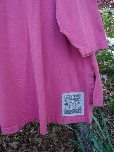 1997 Work Jacket Tiny Moon Geranium OSFA draped outdoors, featuring side slit, BLUE FISH patch, textured buttons, double-layered panels, and varying hemline, embodying vintage Blue Fish creative expression.