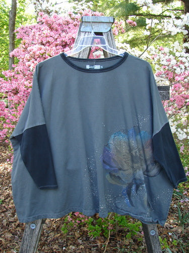 Barclay Cotton Lycra Rib Colors Contrast Sweatshirt Peony Night Grey OSFA featuring a generous boxy shape, floral graphic, contrasting neckline, darker sleeves, and banded hem hanging on a wooden ladder.