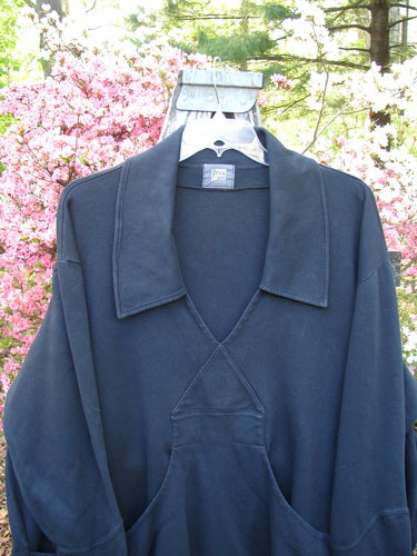 2000 Interlock Peat Bog Top Unpainted Black Size 2: Dark pullover with wide collar, deep V-neck, and kangaroo pocket, displayed on hanger outdoors. Features signature Blue Fish patch and unique hemline design.