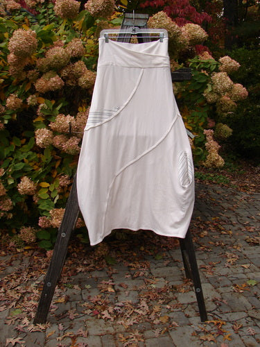Barclay Cotton Lycra Fold Over Lantern Skirt Stripe Cream Size 2 displayed on a wooden ladder, showcasing its fold-over cross-paneled waistline and unique S-shaped exterior stitchery.