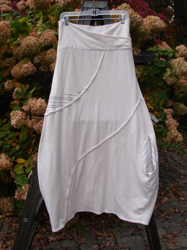 Barclay Cotton Lycra Fold Over Lantern Skirt Stripe Cream Size 2 hanging on a clothesline, showcasing a cross-paneled waistline, curved stitchery, deep drop side pocket, and slightly pegged lower hem.