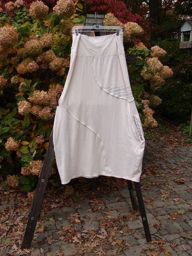 Barclay Cotton Lycra Fold Over Lantern Skirt Stripe Cream Size 2 displayed on a wooden rack, showcasing its unique fold-over waistline and bell shape.
