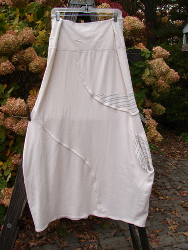 Barclay Cotton Lycra Fold Over Lantern Skirt Stripe Cream Size 2 hanging on a clothesline outdoors, showcasing its unique cross-paneled waistline and graduating bell shape.