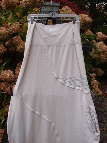 Barclay Cotton Lycra Fold Over Lantern Skirt Stripe Cream Size 2 hanging on a clothesline, showcasing its bell shape, cross paneled waistline, exterior stitchery, and deep drop side pocket.