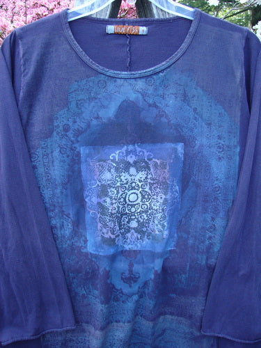 Barclay Long Sleeved A Line Tee Celtic Journey Purple Royal Size 1, featuring a deep indigo hue with a mandala-style print, hangs outdoors showcasing its rounded neckline and cozy long sleeves.