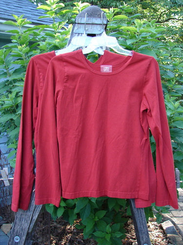 2000 Cotton Lycra Long Sleeved Layering Tops Unpainted Bittersweet Size 1, featuring a fitted silhouette with a rounded neckline, displayed on a hanger.