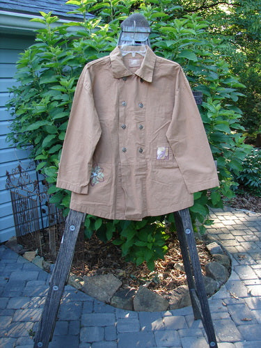 2000 Parachute Double Button Jacket Floral Carmel Altered Size 1 displayed on a wooden ladder, showcasing its double breast line, metal buttons, cuffed sleeves, and rounded hem.