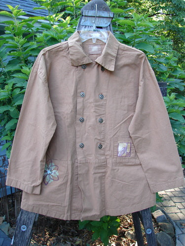 2000 Parachute Double Button Jacket Floral Carmel Altered Size 1 displayed on a pole, highlighting its double-breasted design, metal buttons, cuffed sleeves, and rear walking vent.