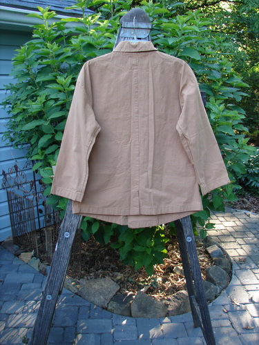 2000 Parachute Double Button Jacket Floral Carmel Altered Size 1 displayed on a wooden rack, showcasing its double breast line, metal buttons, rounded hem, and cuffed sleeves with front pockets.