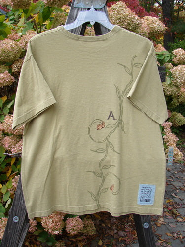 1998 Botanicals Short Sleeved Tee Continuous Vine Seed Size 1, featuring a thicker ribbed neckline and signature Blue Fish patch, with a single vine theme painted on medium weight organic cotton jersey.