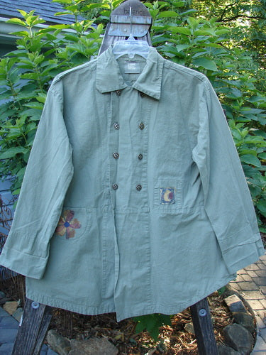 2000 Parachute Double Button Jacket Floral Eucalyptus Size 0, featuring a double-breasted design, 8 metal buttons, cuffed sleeves, rounded hem, and tiny front pockets, displayed on an outdoor mannequin.