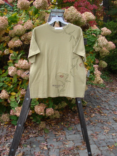 1998 Botanicals Short Sleeved Tee Continuous Vine Seed Size 1 displayed on a wooden hanger, featuring a floral vine design and a thicker ribbed neckline, made from medium-weight organic cotton jersey.