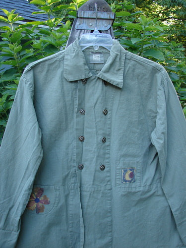 2000 Parachute Double Button Jacket Floral Eucalyptus Size 0 displayed on a hanger, showcasing its double breast line, metal buttons, cuffed sleeves, rounded hem, and tiny front pockets.