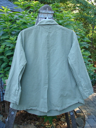 2000 Parachute Double Button Jacket Floral Eucalyptus Size 0 on a clothes rack, featuring metal buttons, double breast line, cuffed sleeves, rounded hem, and floral theme paint.