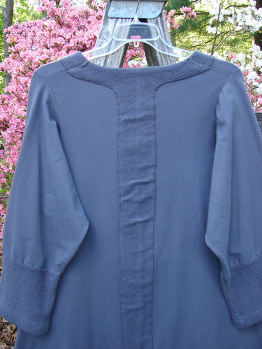 Barclay Cotton Lycra Celtic Moss Single Pocket Tunic Unpainted Grey Plum Size 1 hanging outdoors, showcasing three-quarter sleeves, an A-line shape, and a distinct single front pocket.