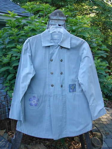 2000 Parachute Double Button Jacket Floral Robin's Egg Altered Size 0 displayed on a swing, featuring a double breast line, cuffed sleeves, rounded hem, and floral theme paint.