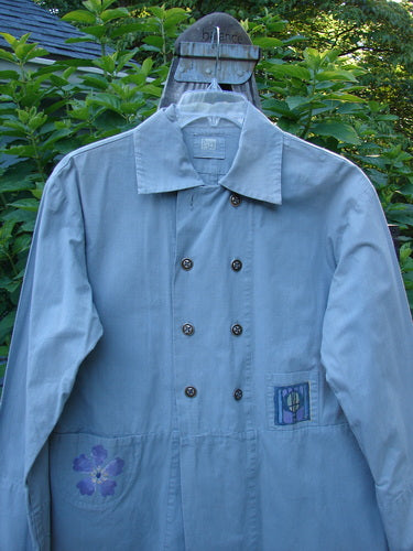 2000 Parachute Double Button Jacket Floral Robin's Egg Altered Size 0 displayed on a hanger, showcasing its double-breasted design, rounded hem, cuffed sleeves, metal buttons, and tiny front pockets.