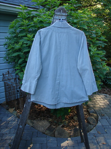 2000 Parachute Double Button Jacket Floral Robin's Egg Altered Size 0 displayed on a wooden rack, featuring cuffed sleeves, a double breast line, and two front pockets.