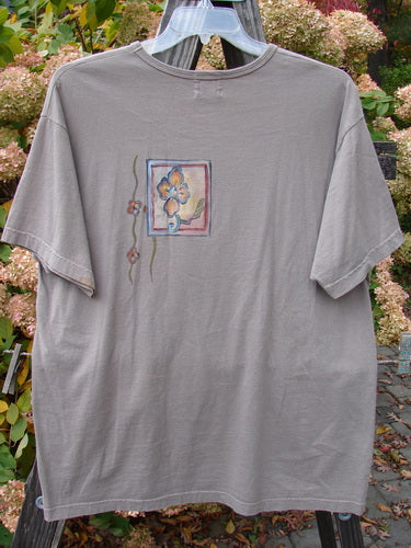 1999 Short Sleeved Tee Circle Bloom Shale Size 1; grey t-shirt with a flower design, featuring a slightly rolled ribbed neckline and a straighter shape, made from medium weight organic cotton.