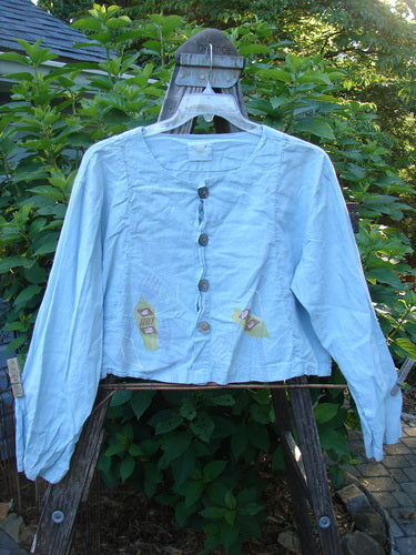 2000 Hemp Cotton Shorty Jacket Tri Rake Blue Jet Size 1 displayed on a swinger, highlighting its rounded hem, neckline, longer sleeves, vertical curved panels, and four shell button closure.