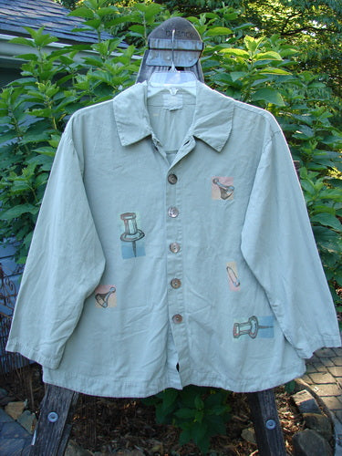 2001 P3 Top Junk Drawer Kelp Size 0: A long-sleeved shirt with unique pictures, featuring 6 abalone shell buttons, a rounded hemline, and a tailored upper back from BlueFishFinder's Spring 2001 collection.