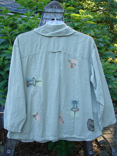 2001 P3 Top Junk Drawer Kelp Size 0: Soft cotton twill jacket on a hanger with abalone shell buttons, rounded hemline, tailored upper back, and shoulder seam.