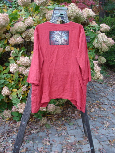 Barclay Linen Tidal Jacket Home Swing Geisha's Robe Altered Size 0 displayed on a wooden stand, highlighting its deeper neckline, double wrap side pockets, and varying front hemline with two-button cross-over closure.