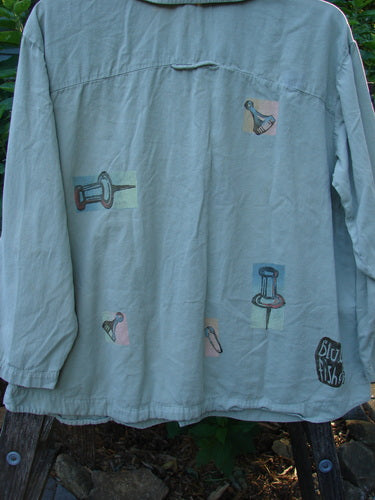 2001 P3 Top Junk Drawer Kelp Size 0: Long-sleeved shirt with unique drawings, featuring six abalone shell buttons, a rounded hemline, and Blue Fish 2001 stamp. Made from soft, buttery cotton twill.